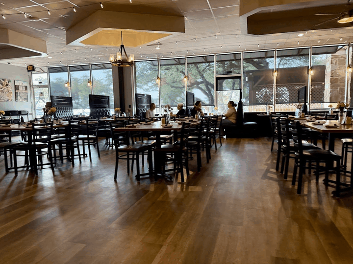 Blue Corn Harvest dining room with wooden tables, chairs and large windows