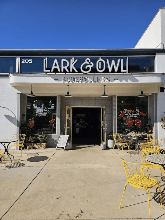Lark & Owl Booksellers storefront with yellow chairs and outdoor tables